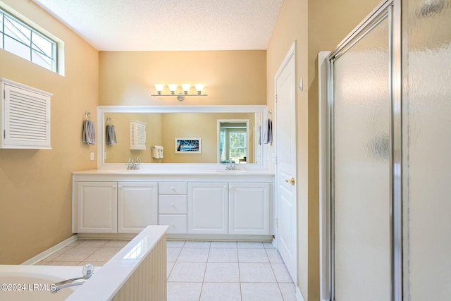 bathroom featuring vanity, an enclosed shower, tile patterned flooring, and a textured ceiling