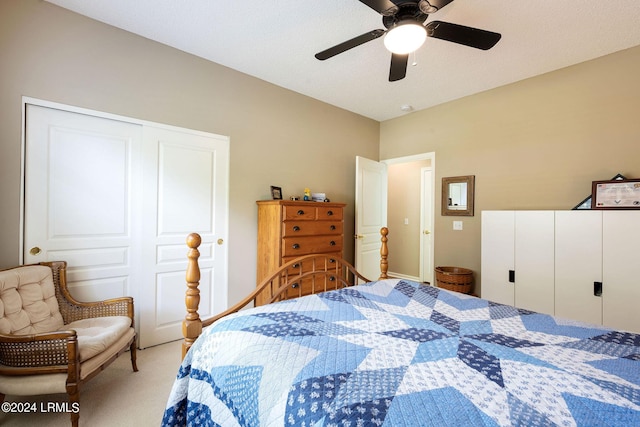 carpeted bedroom with ceiling fan and a closet