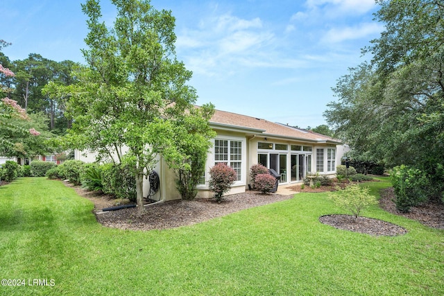 rear view of property featuring a yard