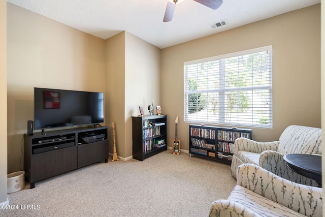 sitting room featuring ceiling fan and light colored carpet