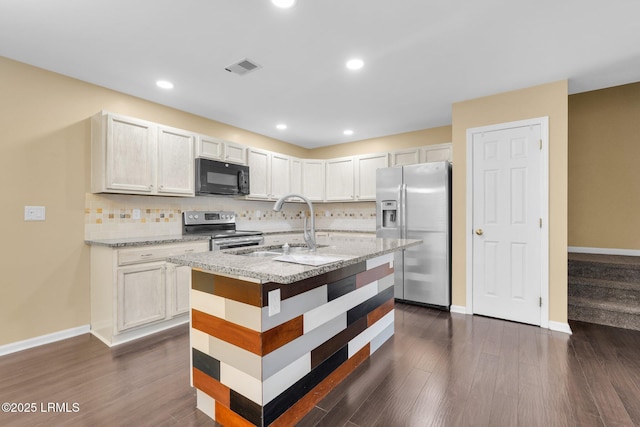 kitchen featuring sink, dark wood-type flooring, stainless steel appliances, white cabinets, and decorative backsplash