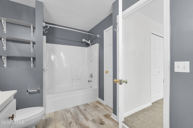 full bathroom with shower / bath combination, vanity, hardwood / wood-style floors, and toilet