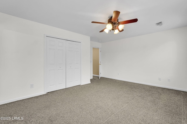 unfurnished bedroom featuring carpet floors, ceiling fan, and a closet