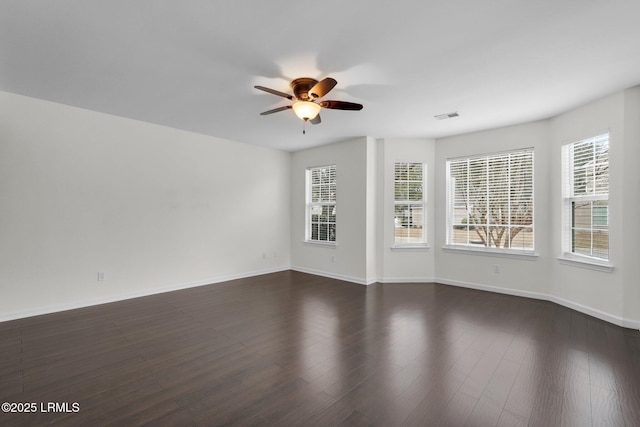 unfurnished room with dark hardwood / wood-style floors and ceiling fan