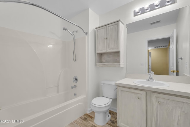 full bathroom with vanity, hardwood / wood-style floors, tub / shower combination, and toilet