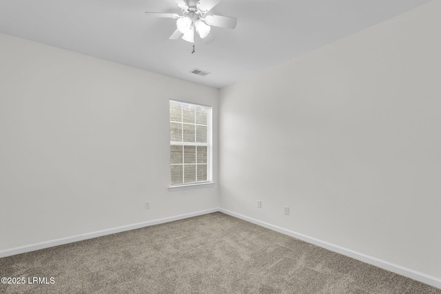 carpeted spare room featuring ceiling fan