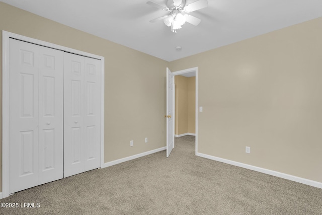 unfurnished bedroom with light carpet, ceiling fan, and a closet