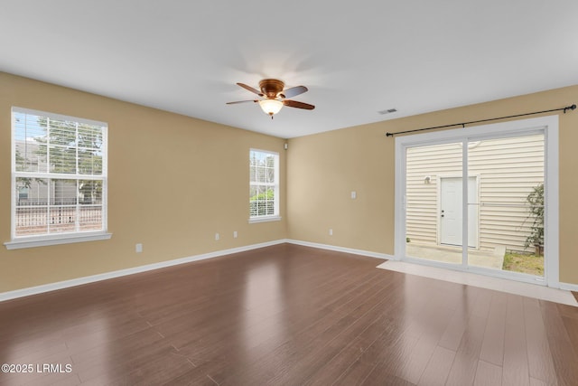 empty room with ceiling fan and dark hardwood / wood-style floors