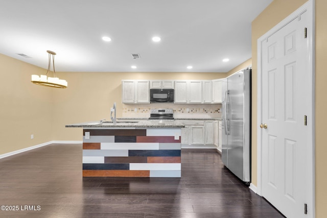 kitchen with sink, white cabinetry, stainless steel appliances, decorative backsplash, and decorative light fixtures