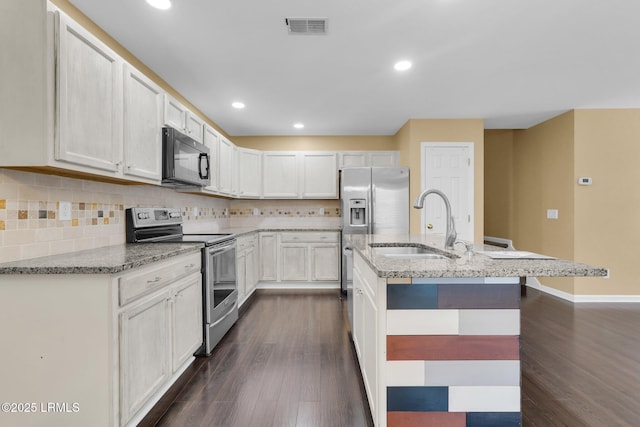 kitchen featuring tasteful backsplash, white cabinetry, sink, stainless steel range with electric cooktop, and dark hardwood / wood-style flooring