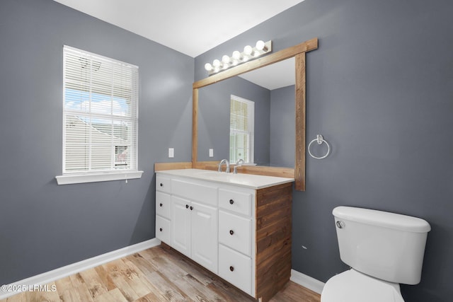 bathroom with vanity, hardwood / wood-style floors, and toilet