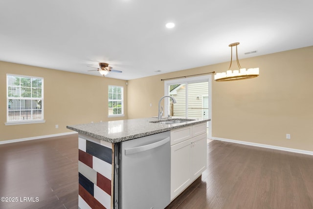 kitchen featuring dishwasher, sink, white cabinets, hanging light fixtures, and light stone counters