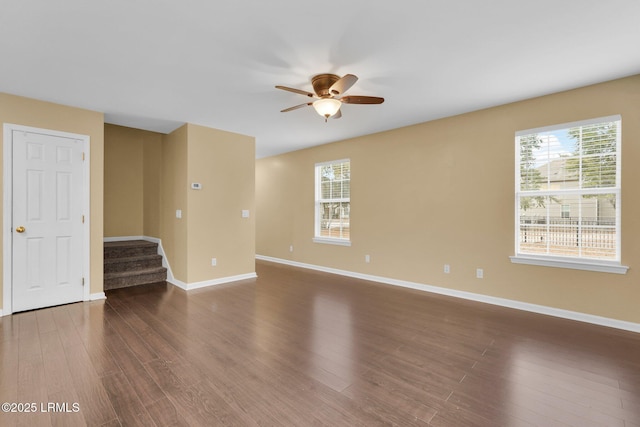 spare room with dark wood-type flooring and ceiling fan