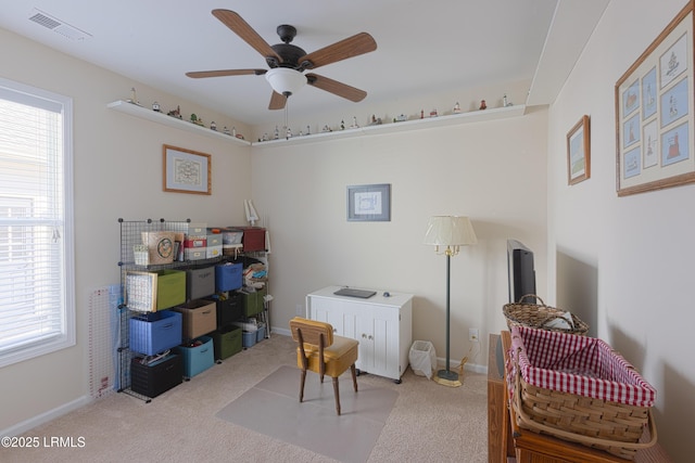 interior space with ceiling fan and carpet floors