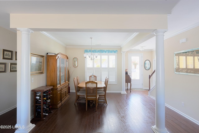 dining space featuring decorative columns, crown molding, dark hardwood / wood-style floors, and a chandelier