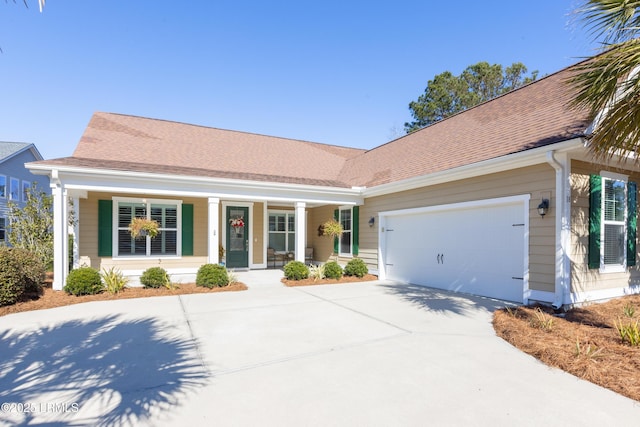 ranch-style home featuring a garage and covered porch