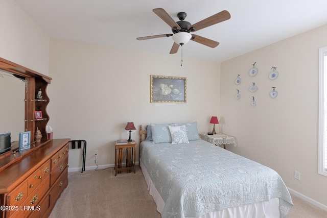 bedroom with light colored carpet and ceiling fan