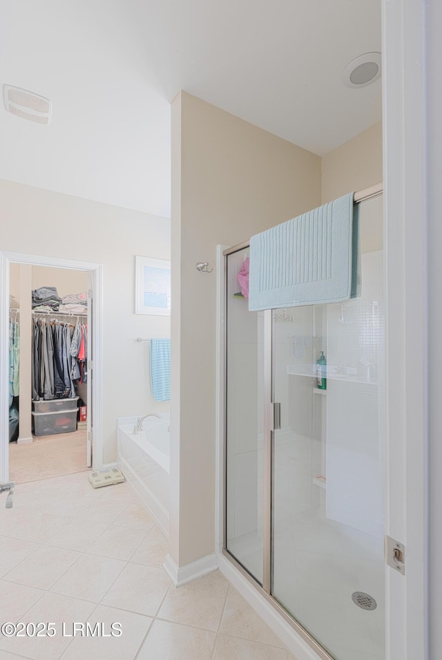 bathroom with tile patterned floors and shower with separate bathtub