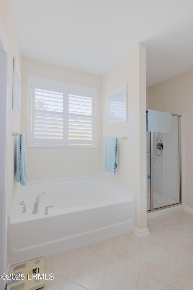 bathroom with tile patterned flooring and separate shower and tub