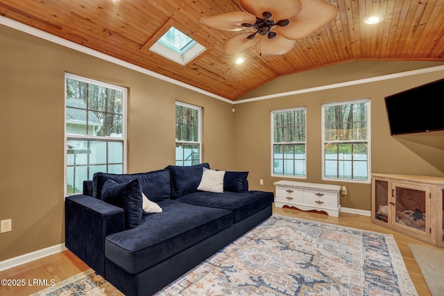 living room with ornamental molding, wood finished floors, vaulted ceiling with skylight, wooden ceiling, and baseboards