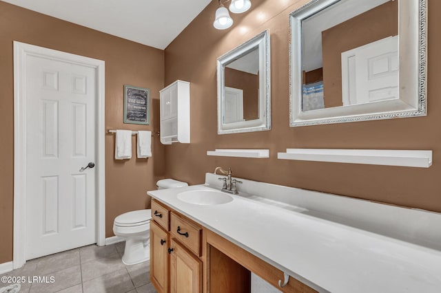 bathroom with tile patterned floors, toilet, and vanity