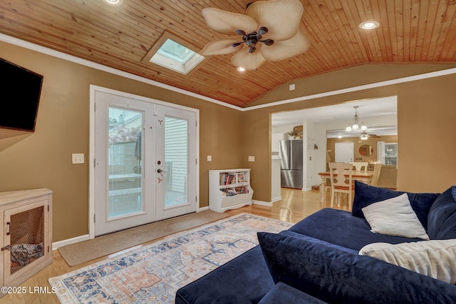 living area with wooden ceiling, vaulted ceiling with skylight, crown molding, and baseboards