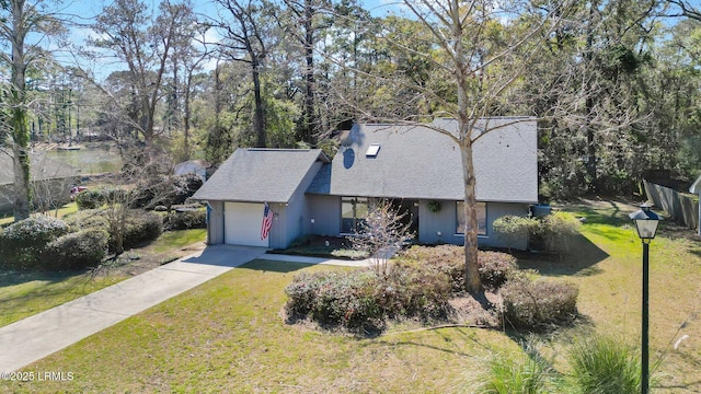 view of front of house featuring driveway, a front lawn, an attached garage, a shingled roof, and a chimney