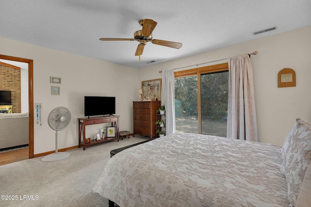 carpeted bedroom featuring ceiling fan, visible vents, baseboards, and access to exterior