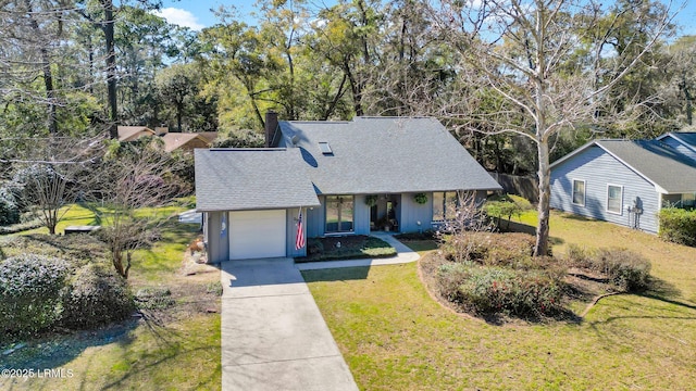 view of front of home featuring an attached garage, concrete driveway, a front lawn, and a shingled roof