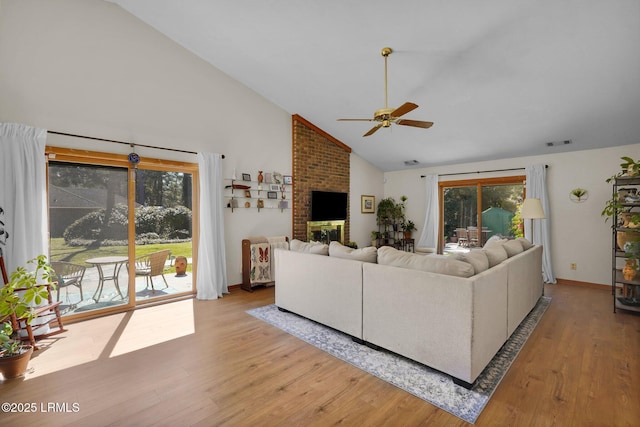 living area featuring plenty of natural light, visible vents, light wood finished floors, and ceiling fan