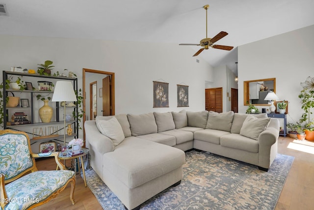 living room featuring a ceiling fan, wood finished floors, visible vents, and high vaulted ceiling