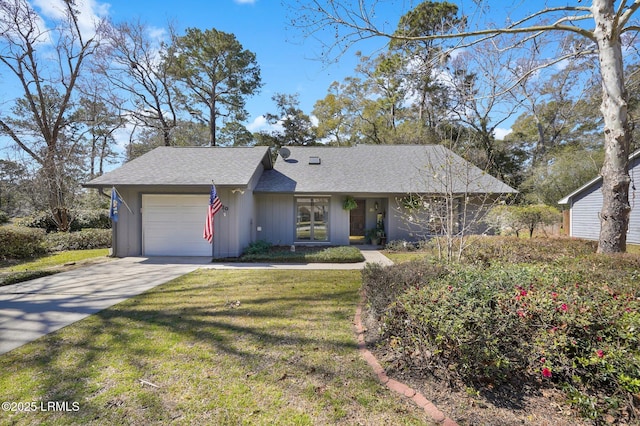 view of front of house with a front lawn, concrete driveway, a garage, and a shingled roof