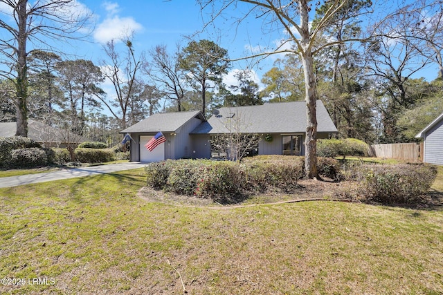 single story home featuring driveway, a front yard, a garage, and fence