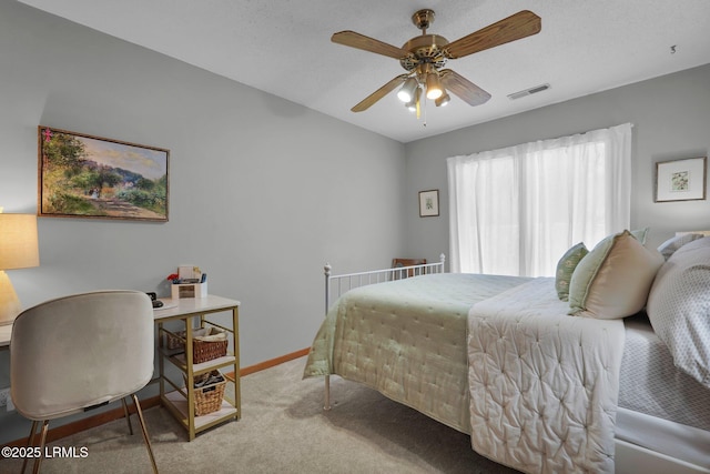 carpeted bedroom featuring a ceiling fan, baseboards, and visible vents