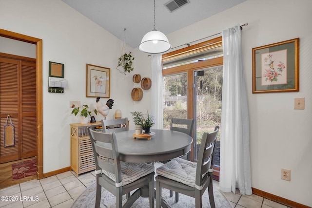 dining space with light tile patterned floors, baseboards, and visible vents