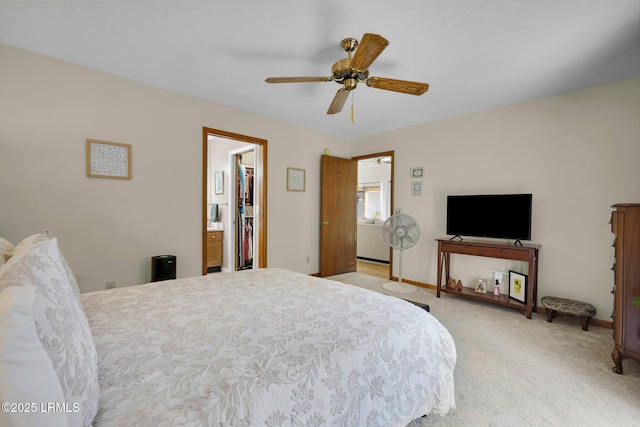 bedroom featuring baseboards, light carpet, ensuite bath, and ceiling fan