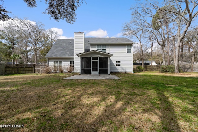 back of property featuring a sunroom, a fenced backyard, a chimney, and a yard