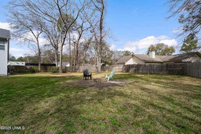 view of yard featuring an outdoor fire pit and a fenced backyard