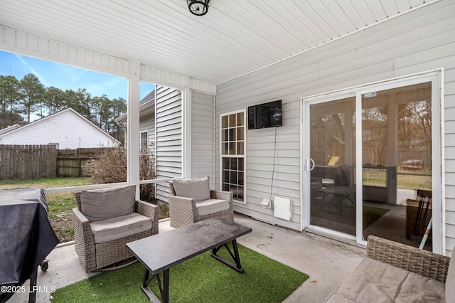 view of patio featuring a grill and fence