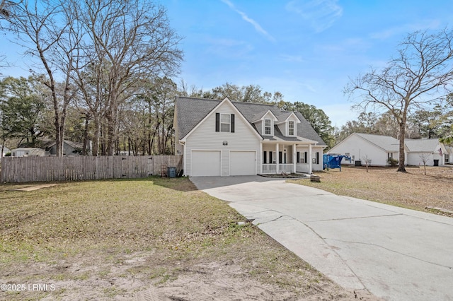 view of front of property featuring a porch, a garage, fence, concrete driveway, and a front yard