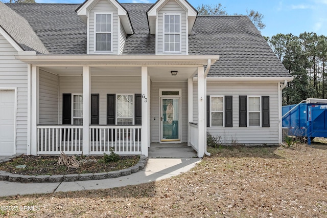 cape cod-style house featuring a porch and roof with shingles