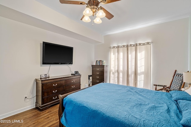 bedroom featuring ceiling fan, baseboards, and wood finished floors