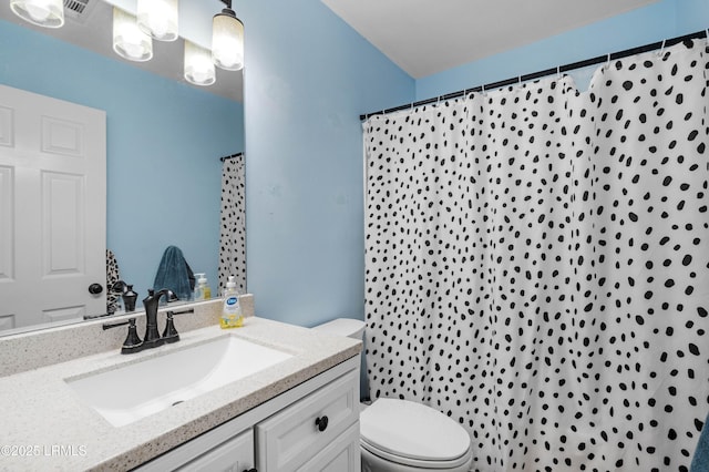 bathroom with a shower with shower curtain, vanity, and toilet