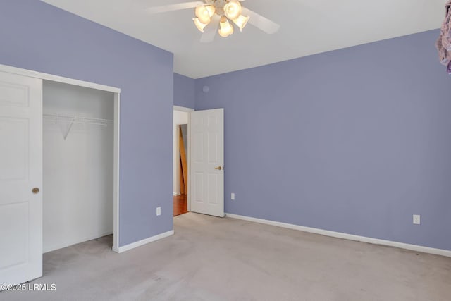 unfurnished bedroom featuring light carpet, a closet, a ceiling fan, and baseboards