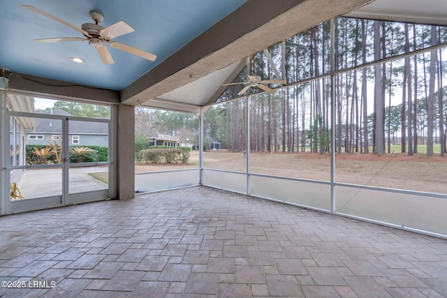 unfurnished sunroom featuring ceiling fan