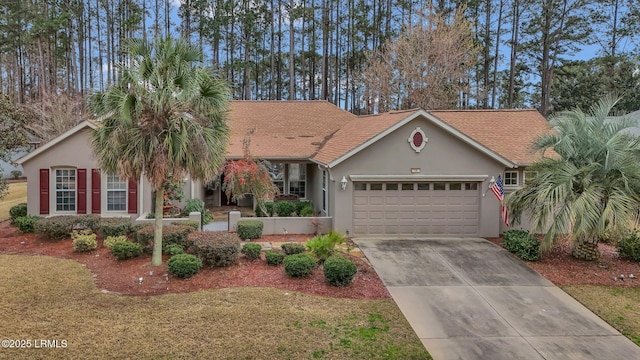 view of front of home featuring a garage, concrete driveway, a front lawn, and stucco siding