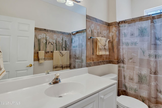 full bath featuring toilet, curtained shower, and vanity