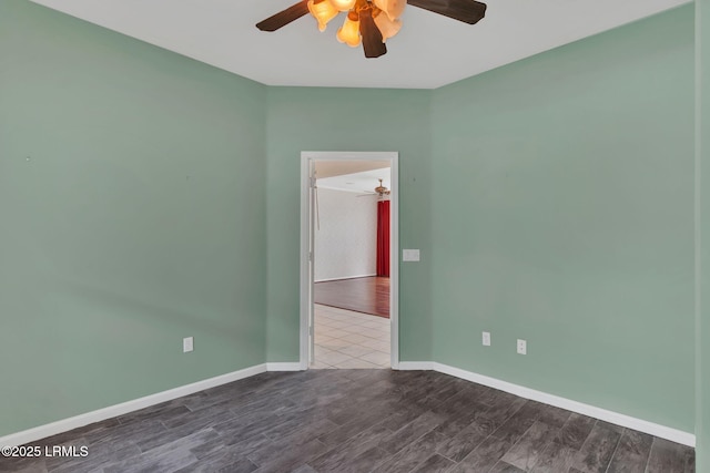 empty room featuring wood finished floors, a ceiling fan, and baseboards