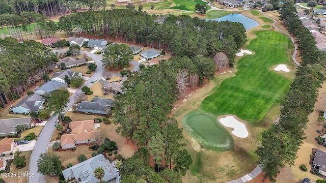 drone / aerial view with a water view, a residential view, and golf course view