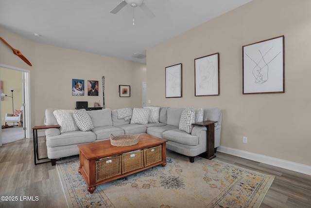 living room with ceiling fan and light wood-type flooring